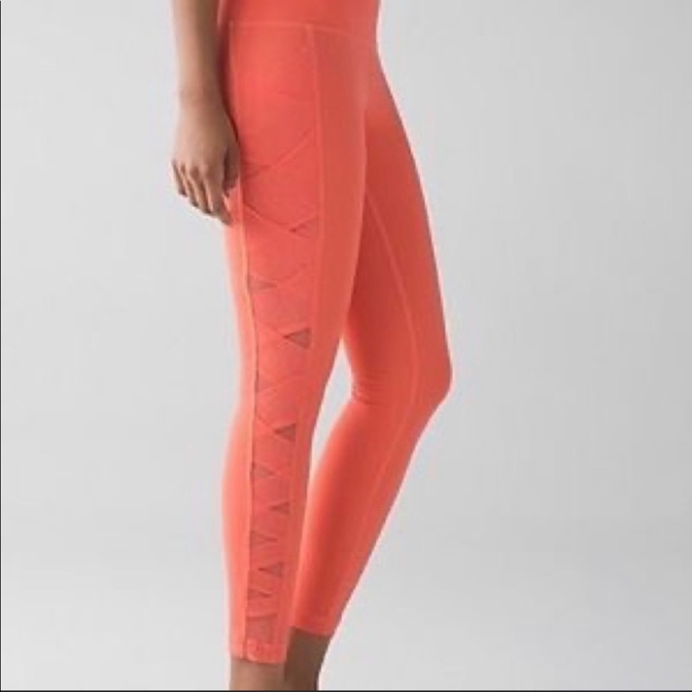 Lululemon Rise and Flow legging in Cape Red coral color with pockets, high rise!